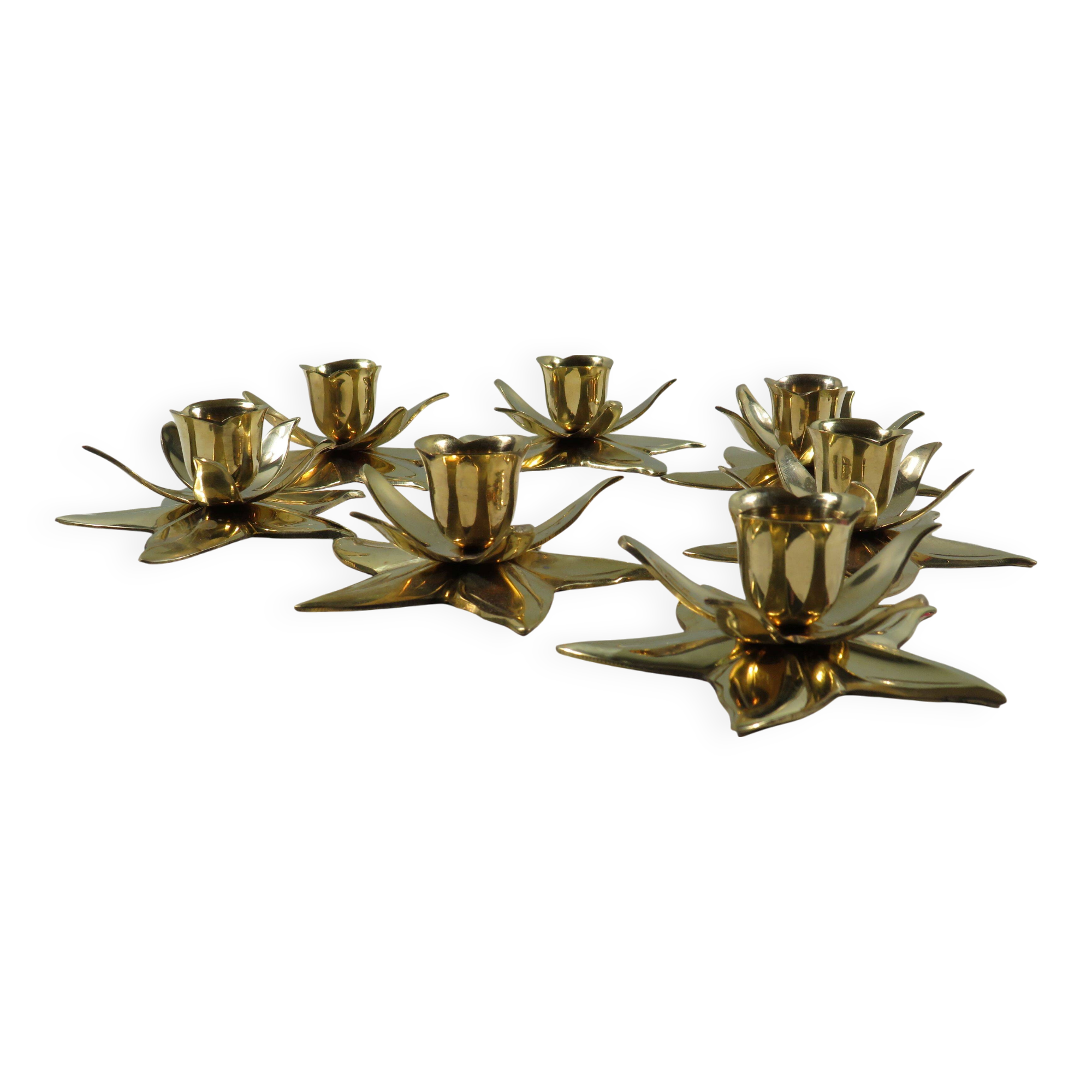 Set of 7 heavy shiny brass flower shaped candle holders, 1970-1980