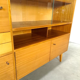 Vintage wooden sideboard with sliding glass doors and drawers