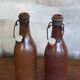 Set of 2 sandstone bottles with ceramic capsule