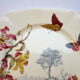 Assiette polychrome signée Kg Luneville 19ème lys et papillons