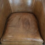 Characterful club chair made of sheepskin leather with light cognac colours