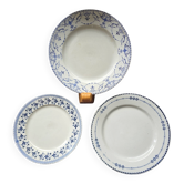 A lot of mismatched plates with a blue rim.