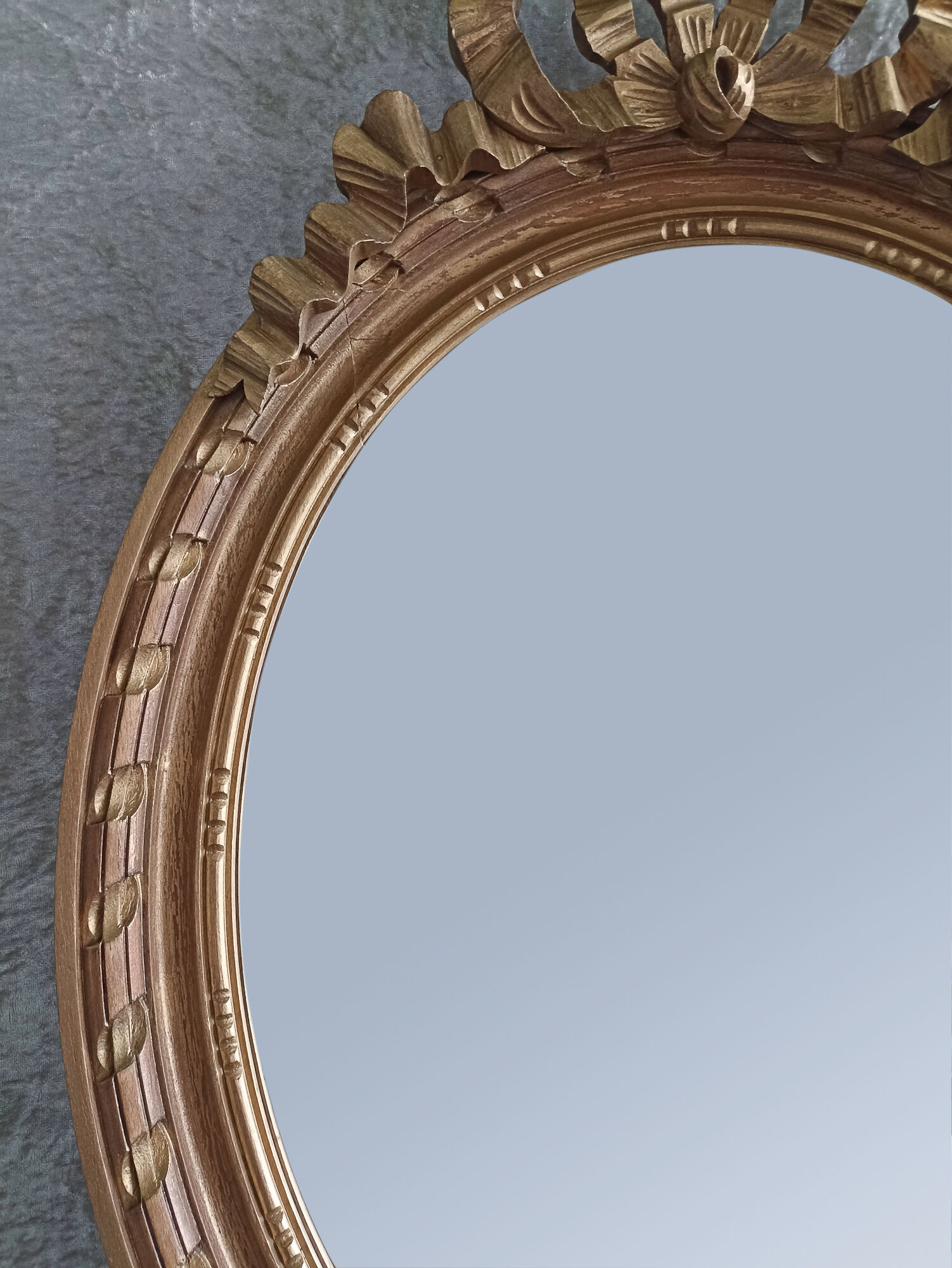 Oval mirror in carved and gilded wood in Louis XVI style