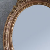 Oval mirror in carved and gilded wood in Louis XVI style