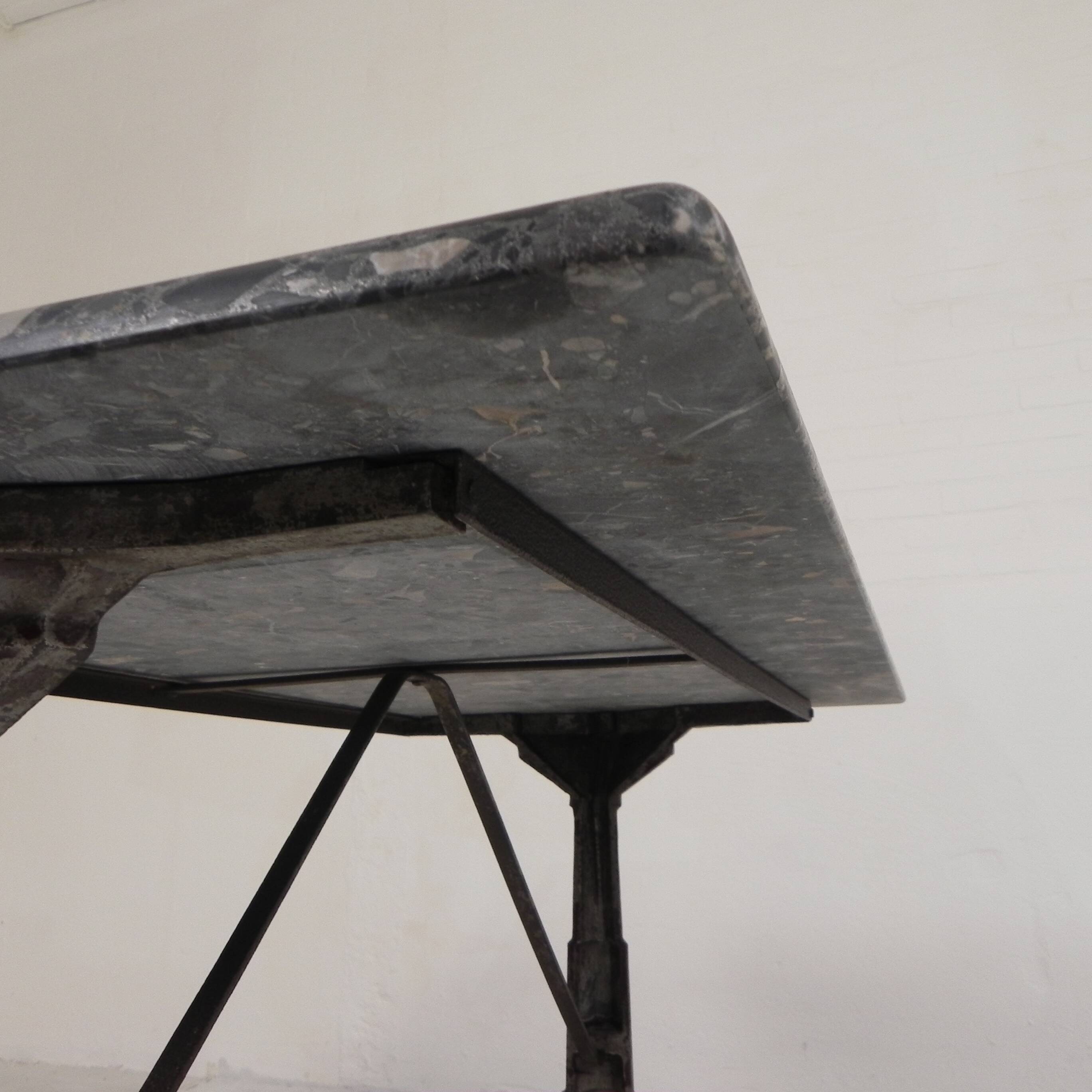 Bistro table with a marble top on a cast iron frame, 1930s.