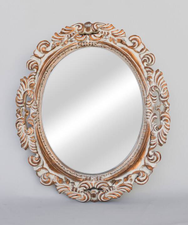 Distressed and carved golden oval mirror in wood.