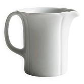 White porcelain milk jug, elegant design.