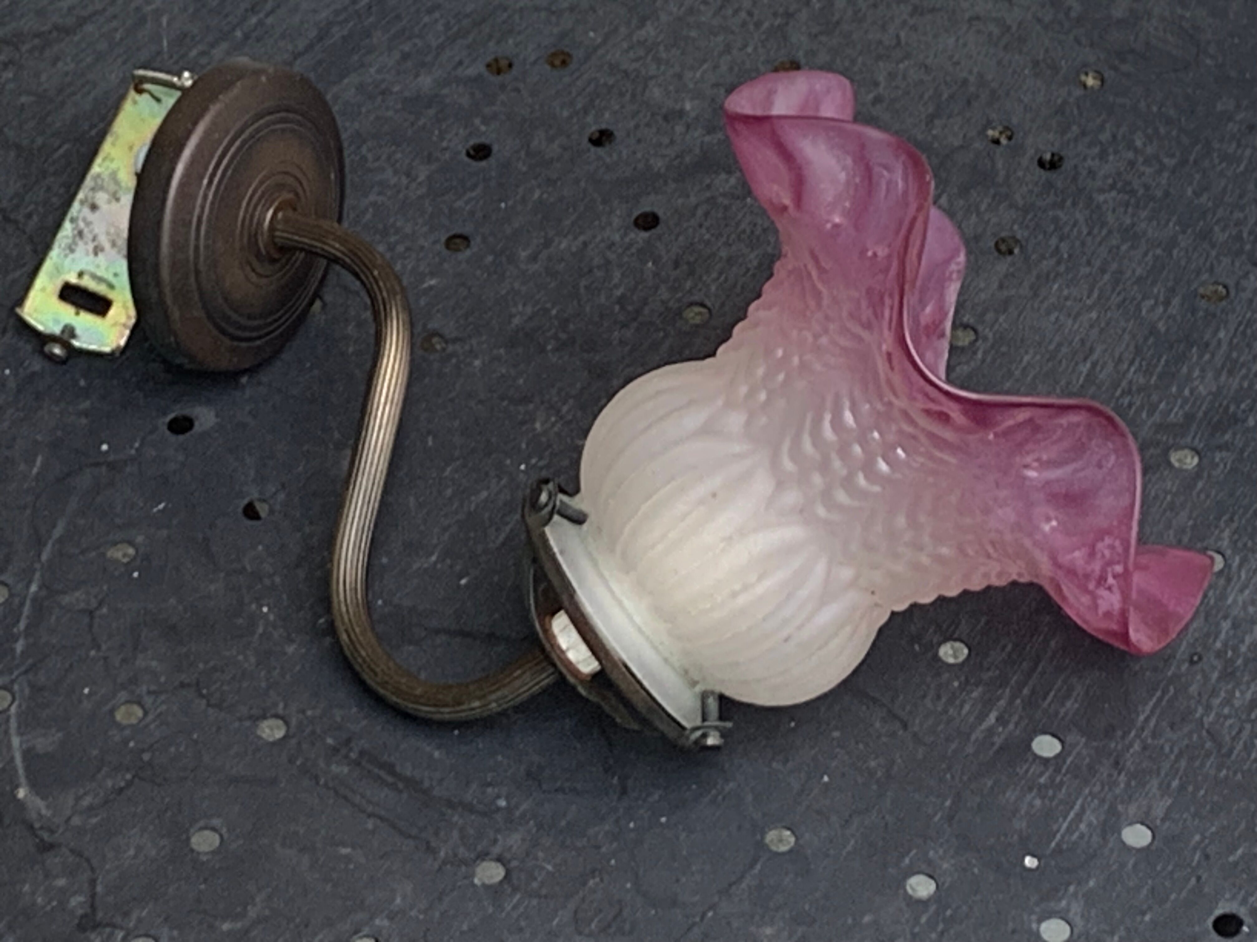 Metal wall lamp with frosted glass shade in the shape of a pink corolla