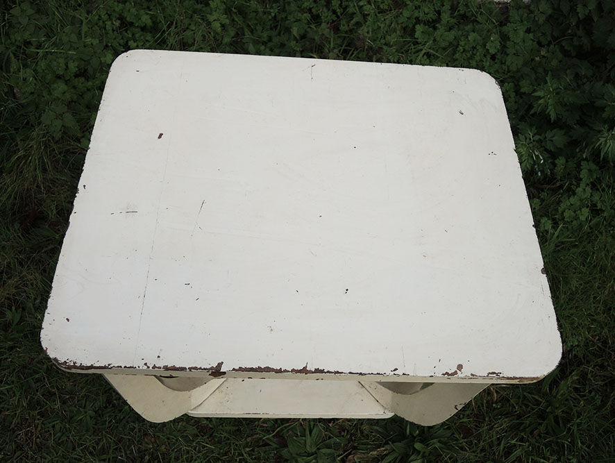Old white wooden peestal table in art deco style
