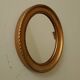 Small vintage oval mirror in gilded resin from the 60s/70s.