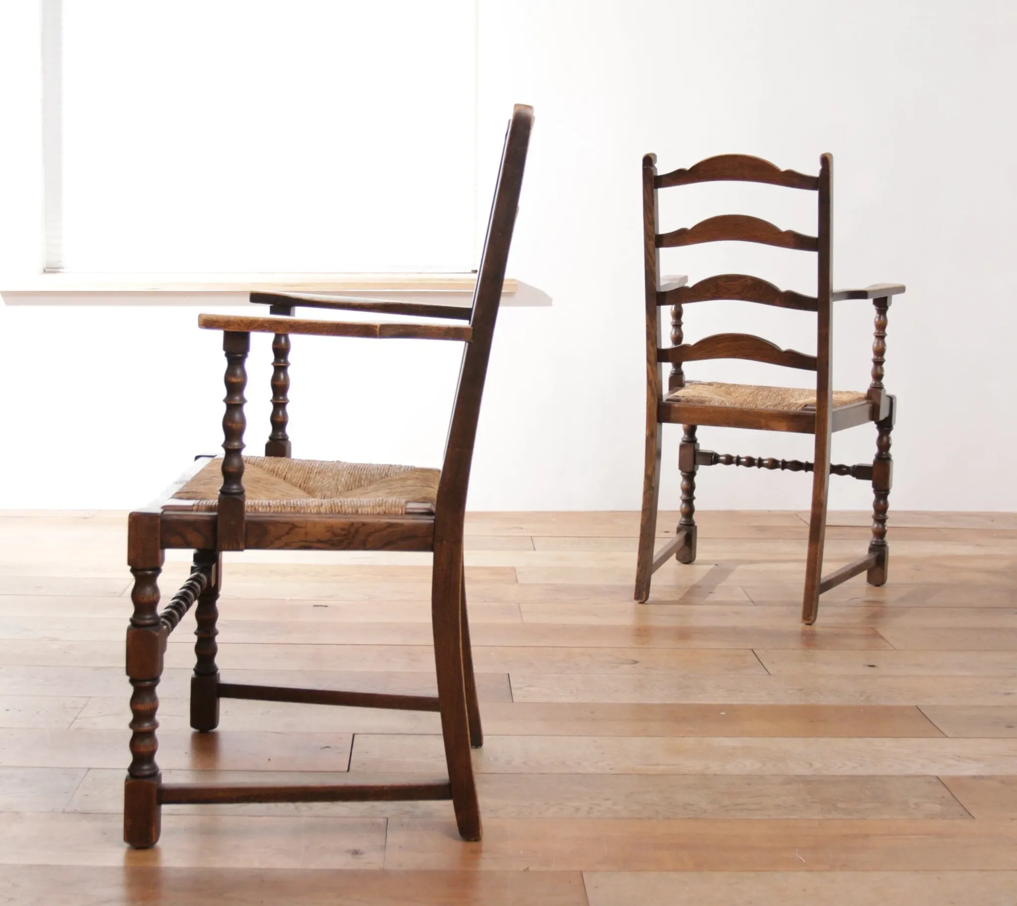 Pair of English oak armchairs with ladder back and rush seats
