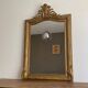 Miroir doré fin 19ème avec fronton décoré 110x75