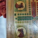 old wooden game board: small horses and checkers
