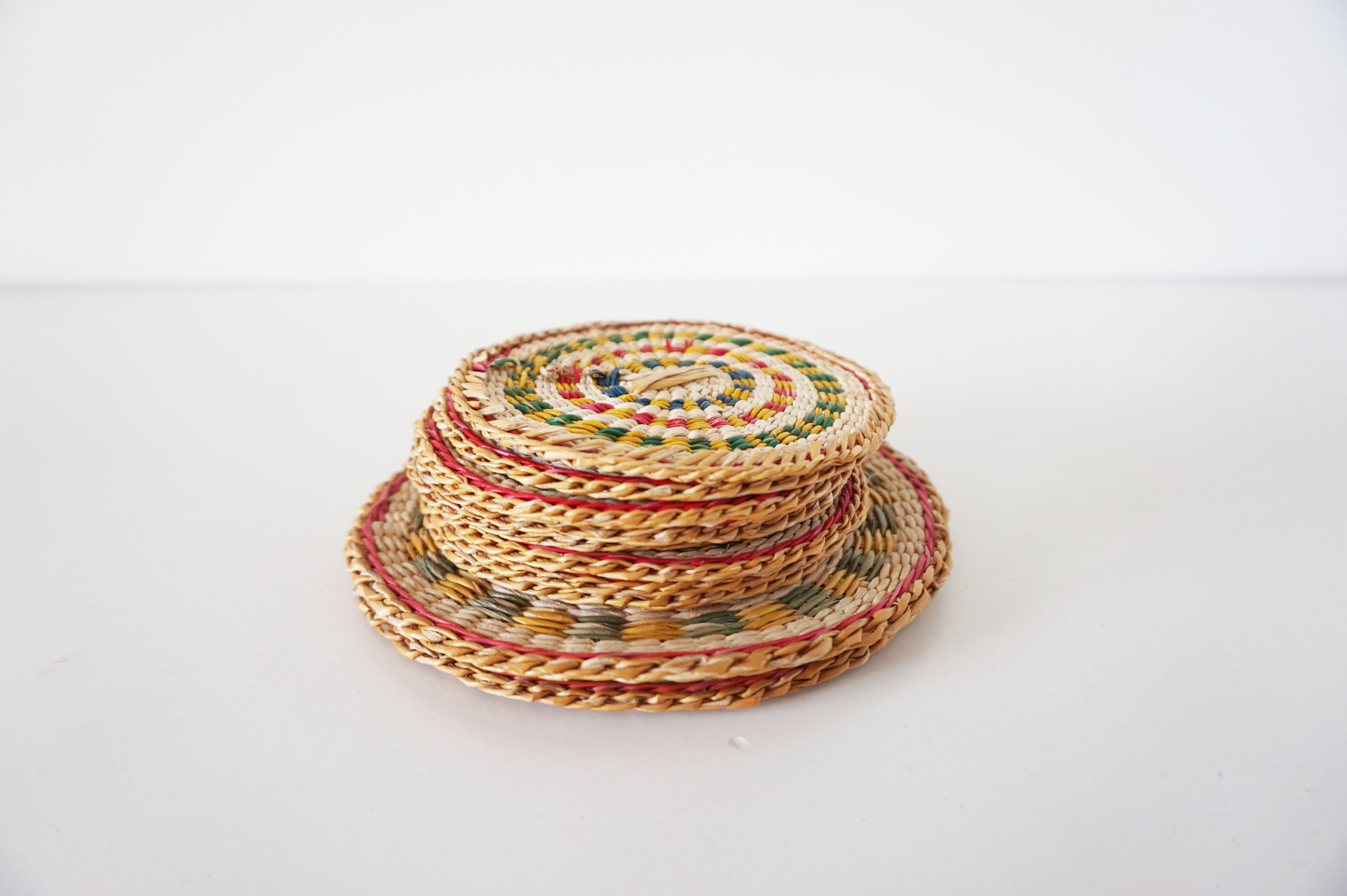 Set of coasters and bottles in colored wicker