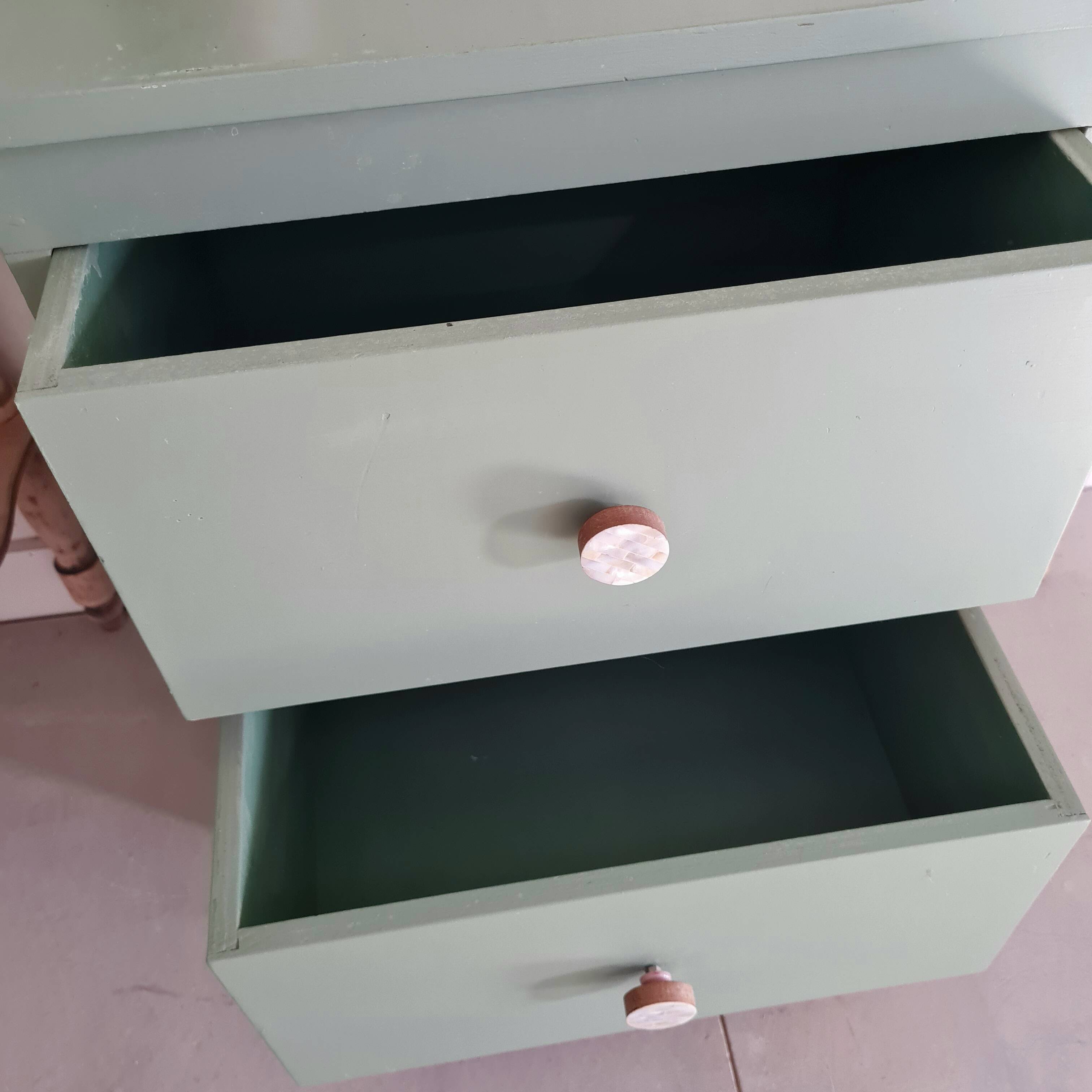 Old chest of drawers with two green drawers