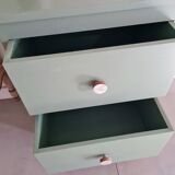 Old chest of drawers with two green drawers