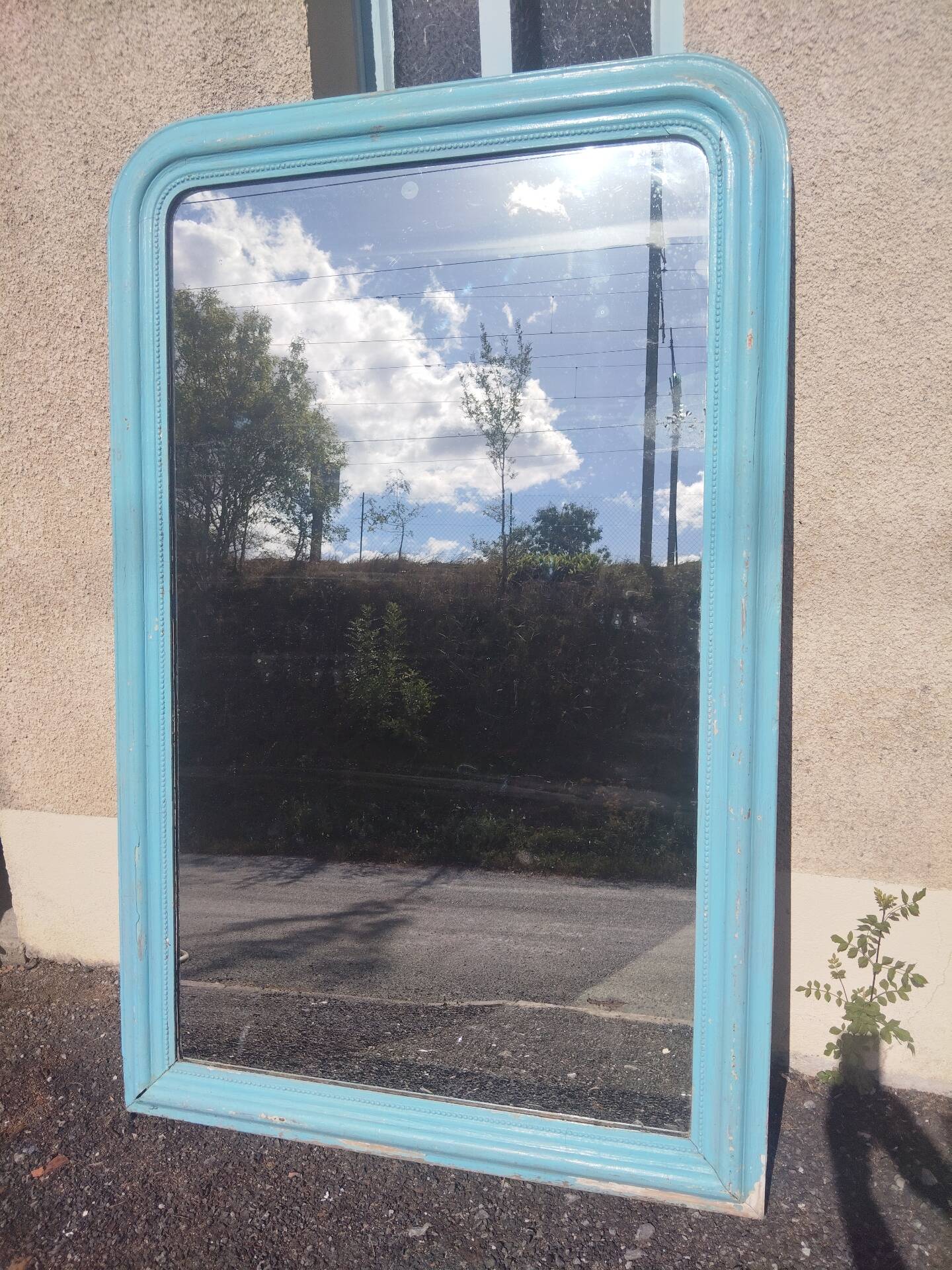 Large Louis-Philippe mirror from the 19th century in wood and stucco with a turquoise blue patina.