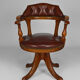 Swivel Chesterfield armchair in wood and leather