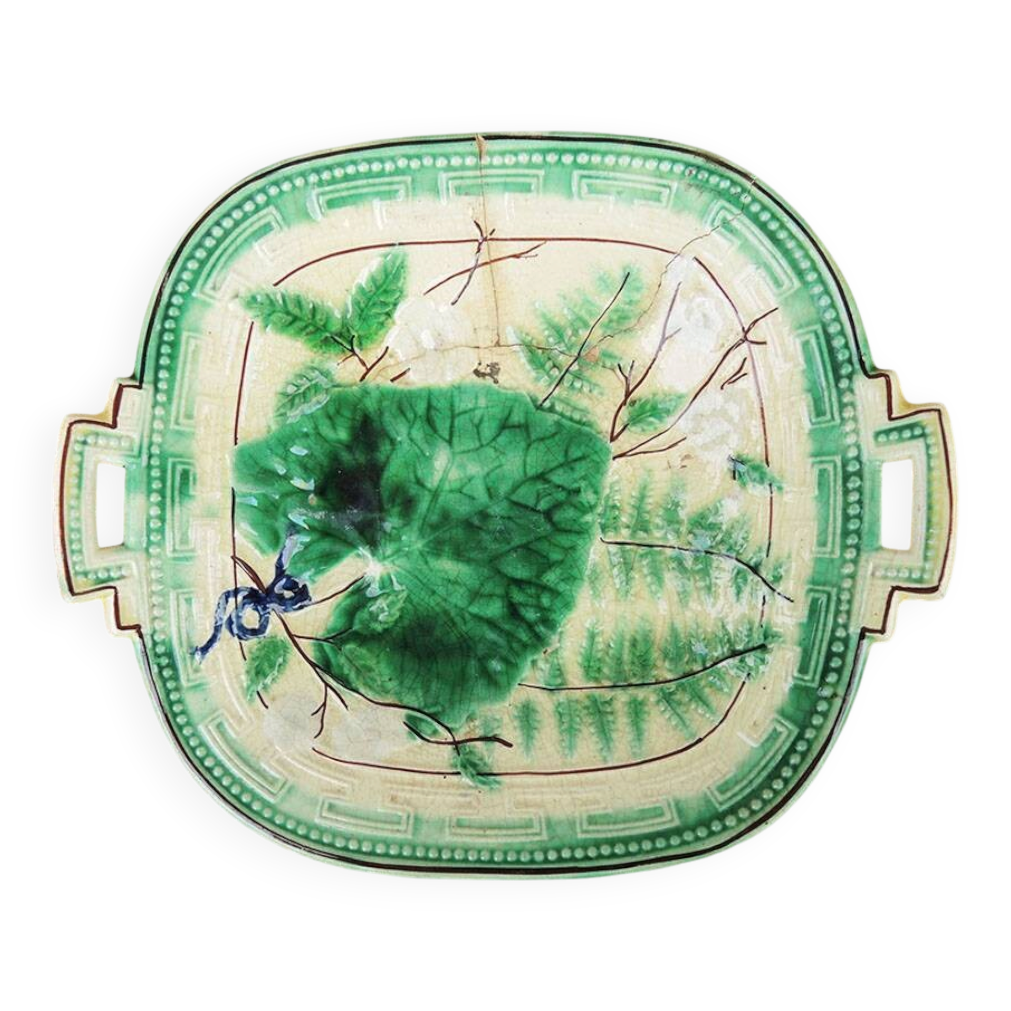 Old square plate in slipware with plant decoration.