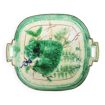 Old square plate in slipware with plant decoration.