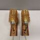A set of wall lamps in teak wood, with amber colored glass