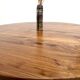 Modernist round table in solid elm, crossed legs.