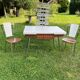 White Formica table with extensions and 2 designer chairs