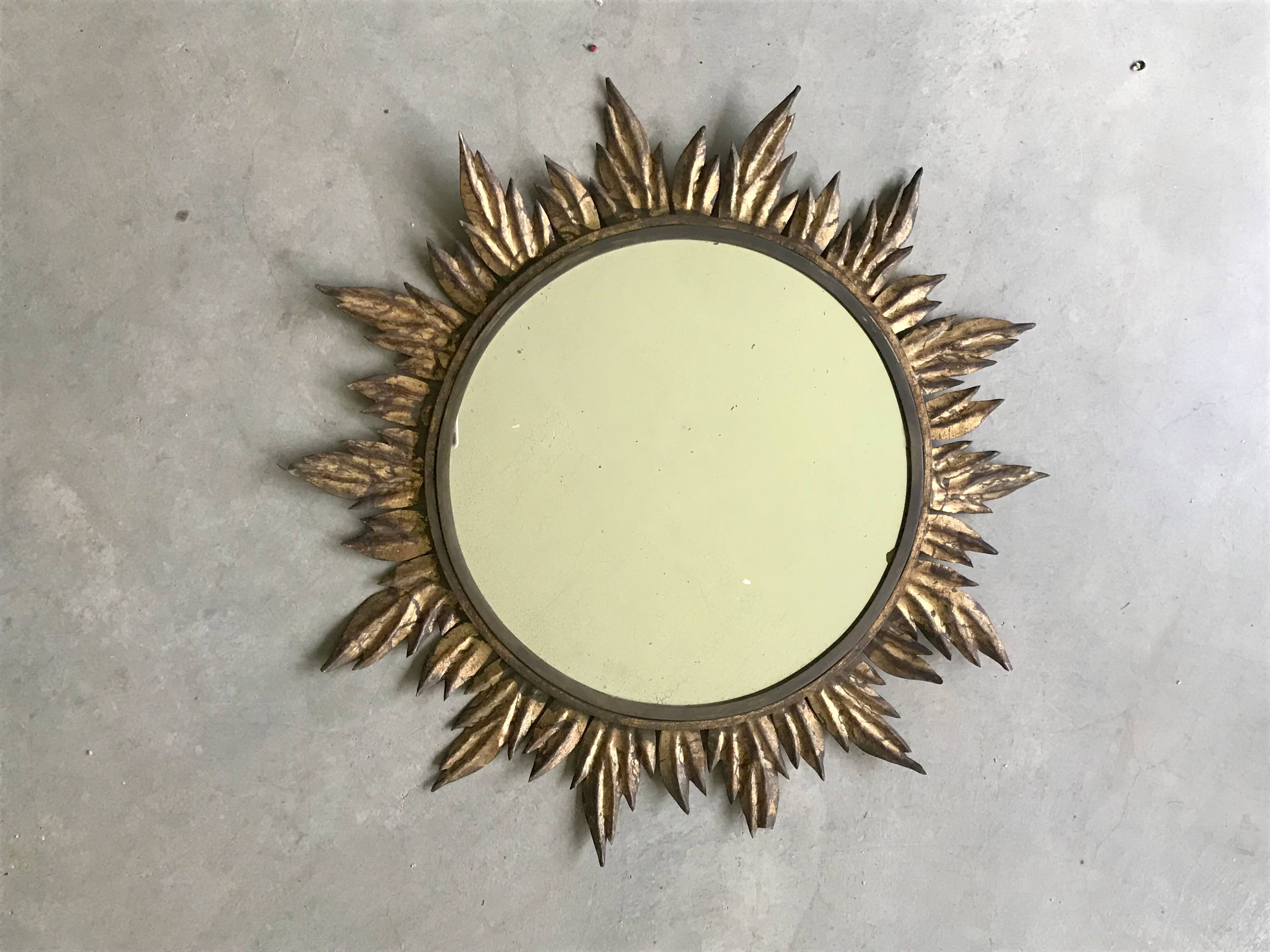 Sun mirror decorated with golden leaves, circa 1950.