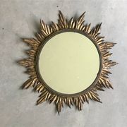 Sun mirror decorated with golden leaves, circa 1950.
