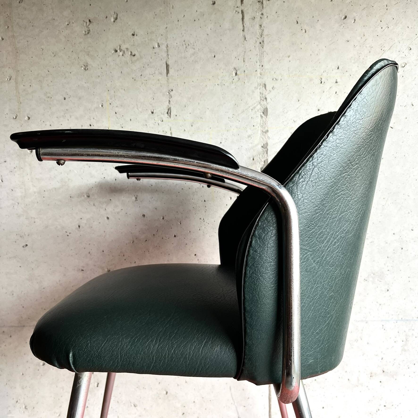 Vintage green faux leather and chrome armchair