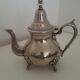 Oriental teapot in silver metal