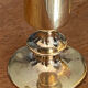 Set of candlesticks and tubular vases in solid brass.