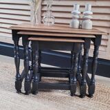 Nest tables in wood and black.
