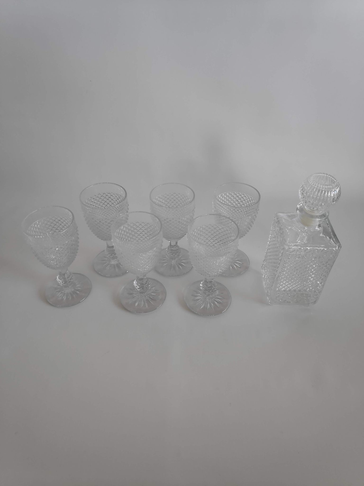 Vintage molded glass foot glasses and carafe from the years 60