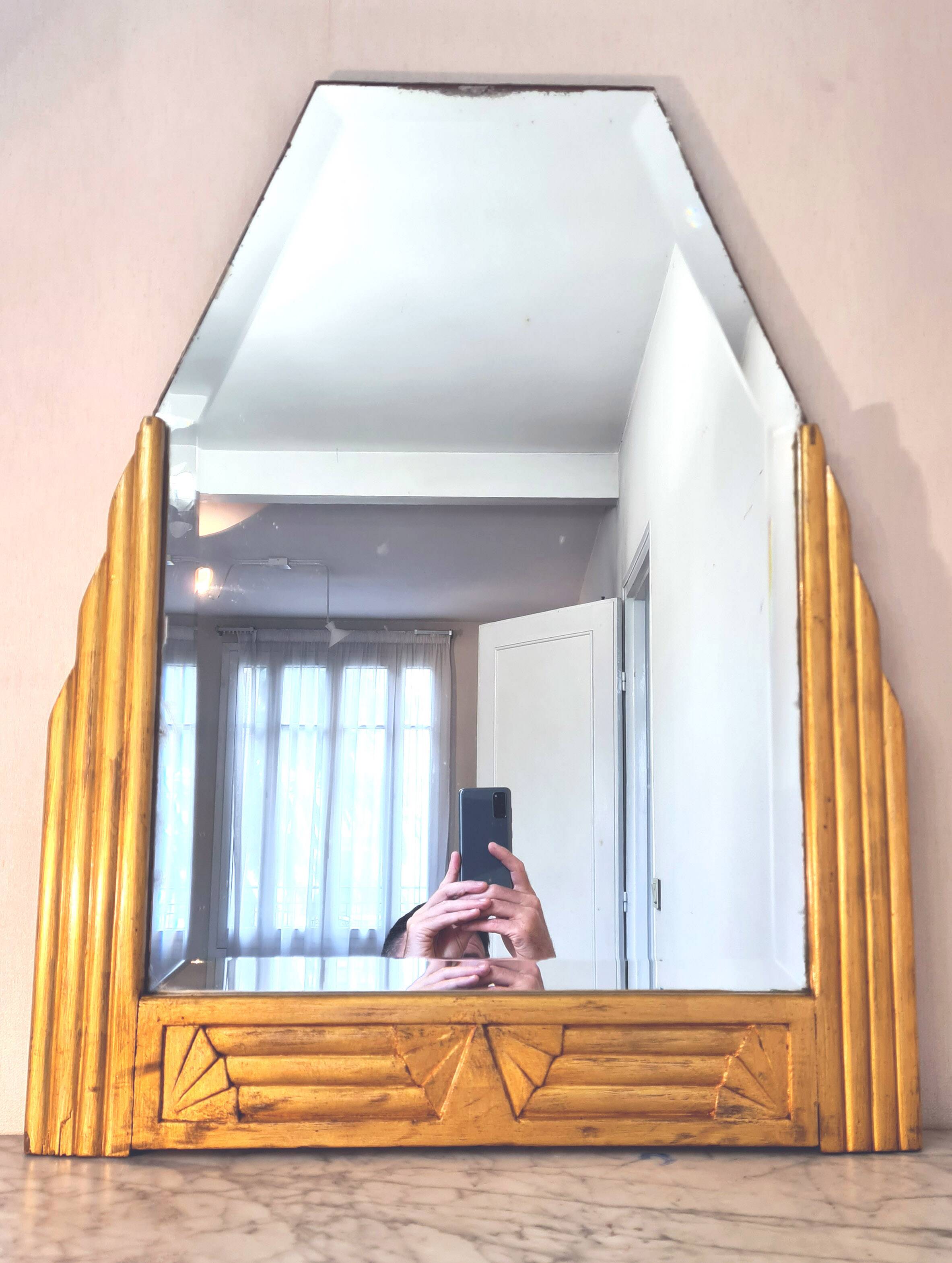 Antique Art Deco mercury mirror, in carved wood with gold leaf.