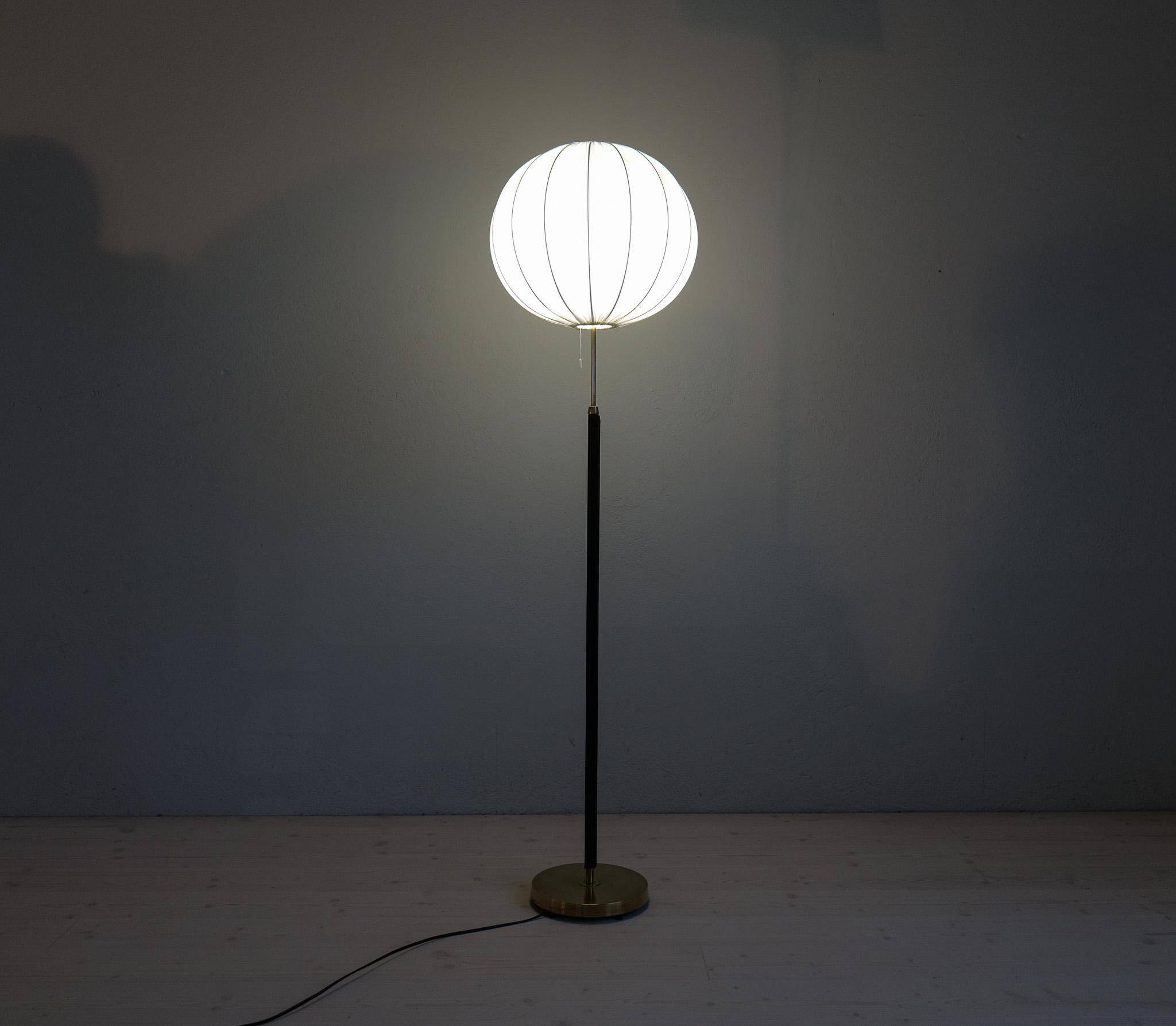 Mid-century black leather and brass floor lamp by Falkenbergs Belysning, Sweden, 1960s.