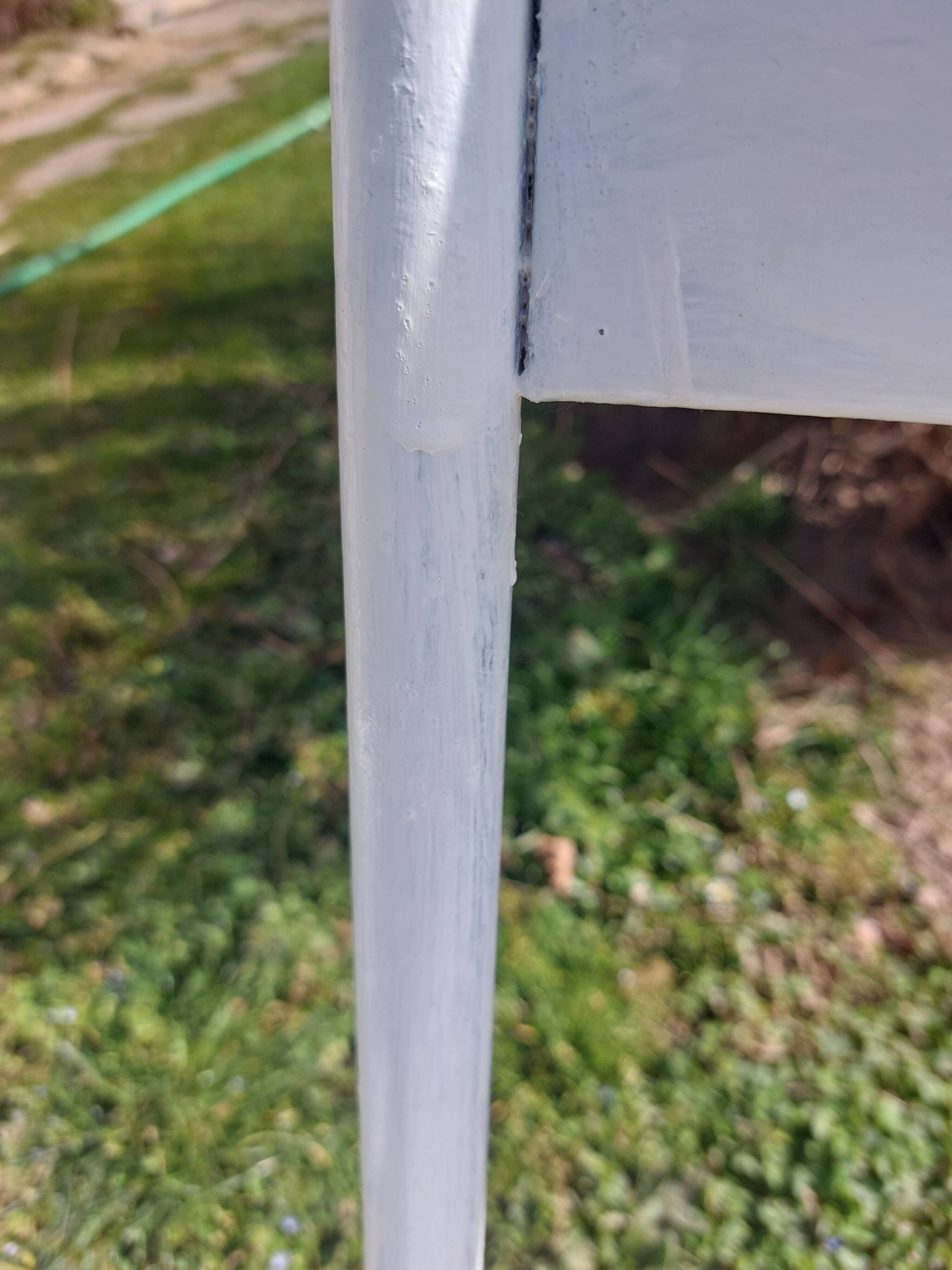 pair of white metal chairs, Tolix style