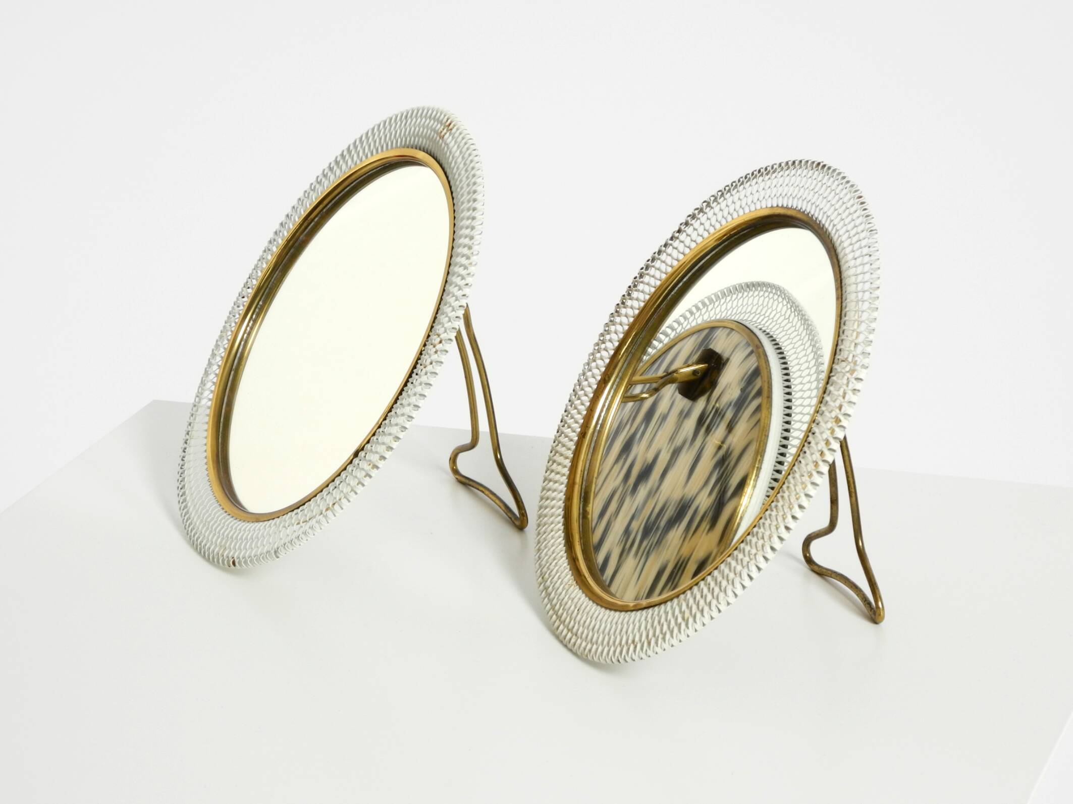 Pair of rare small Mid Century Modern table mirrors with expanded metal fra