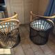 Pair of vintage rattan armchairs with soft fabric seats