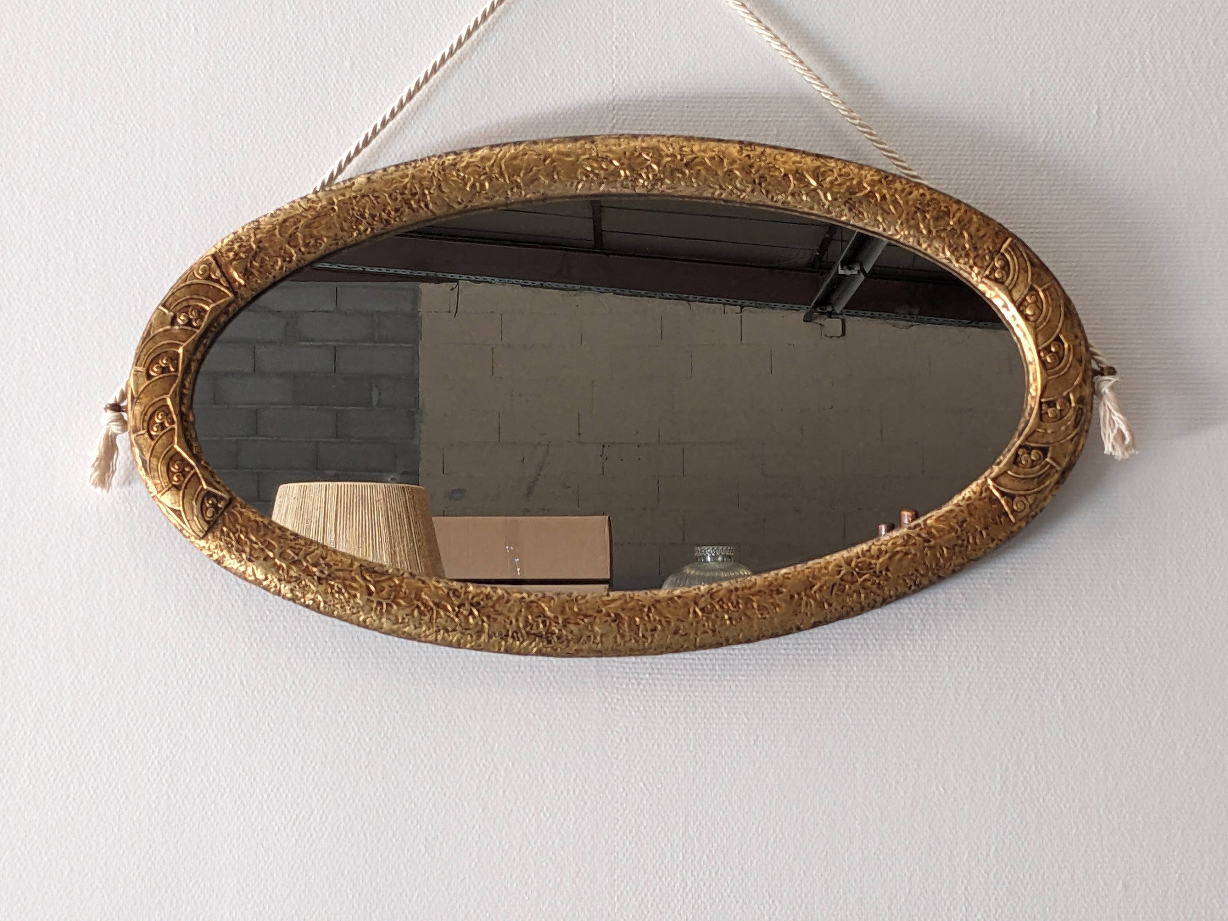 Art Deco oval mirror in gilded wood, France circa 1920