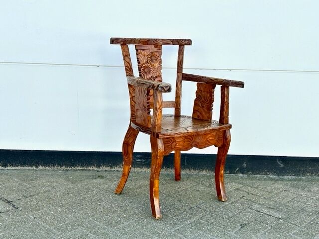 Hand stabbed teak armchair