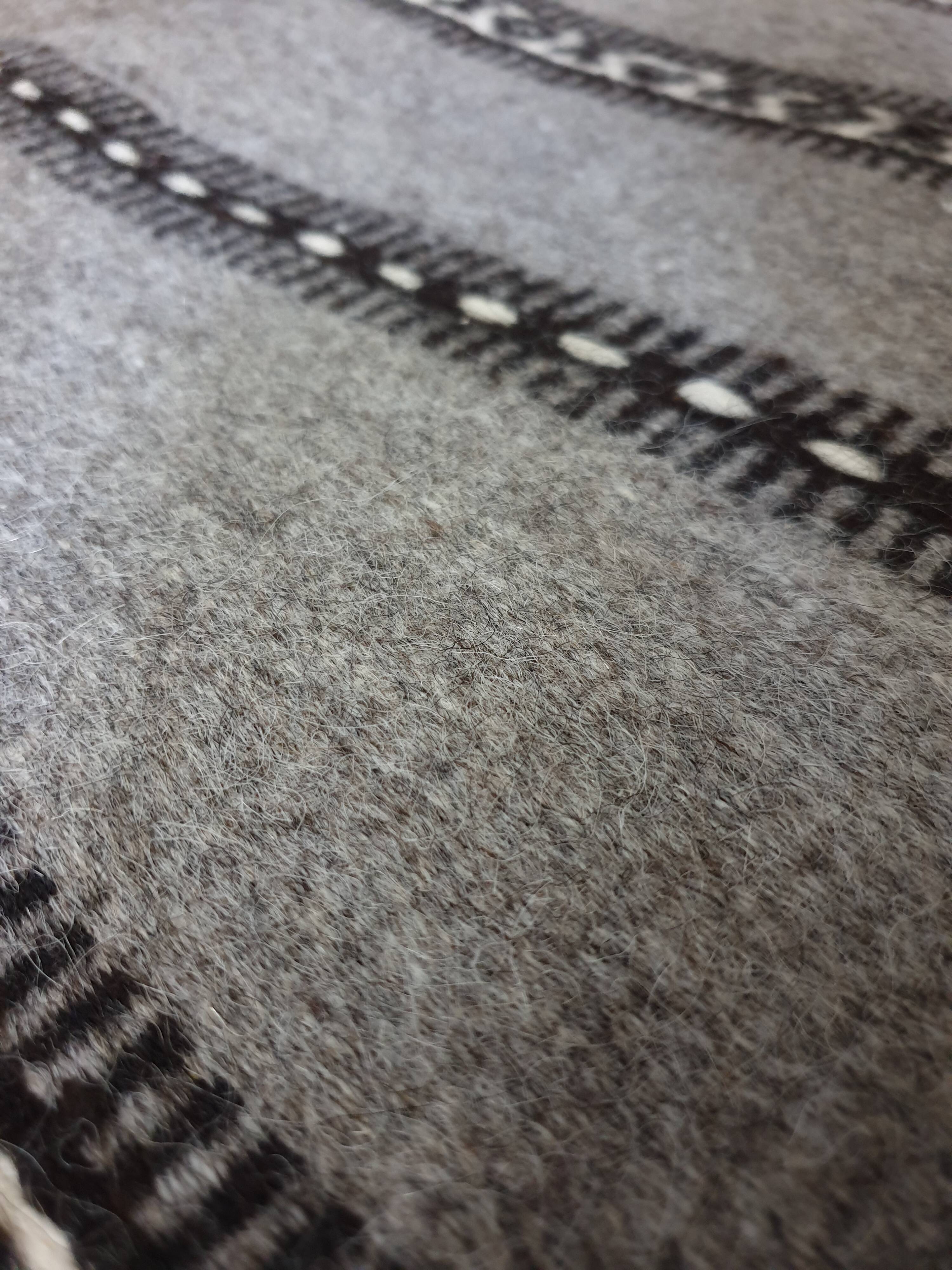 Handwoven vintage geometrical rug, grey background