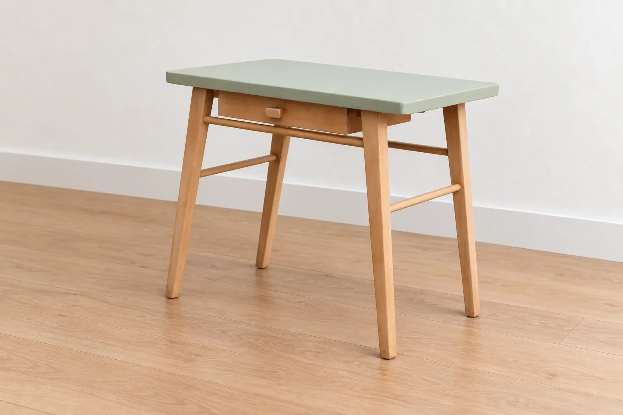 Small vintage children's desk attributed to Baumann – natural wood and lizard green top.