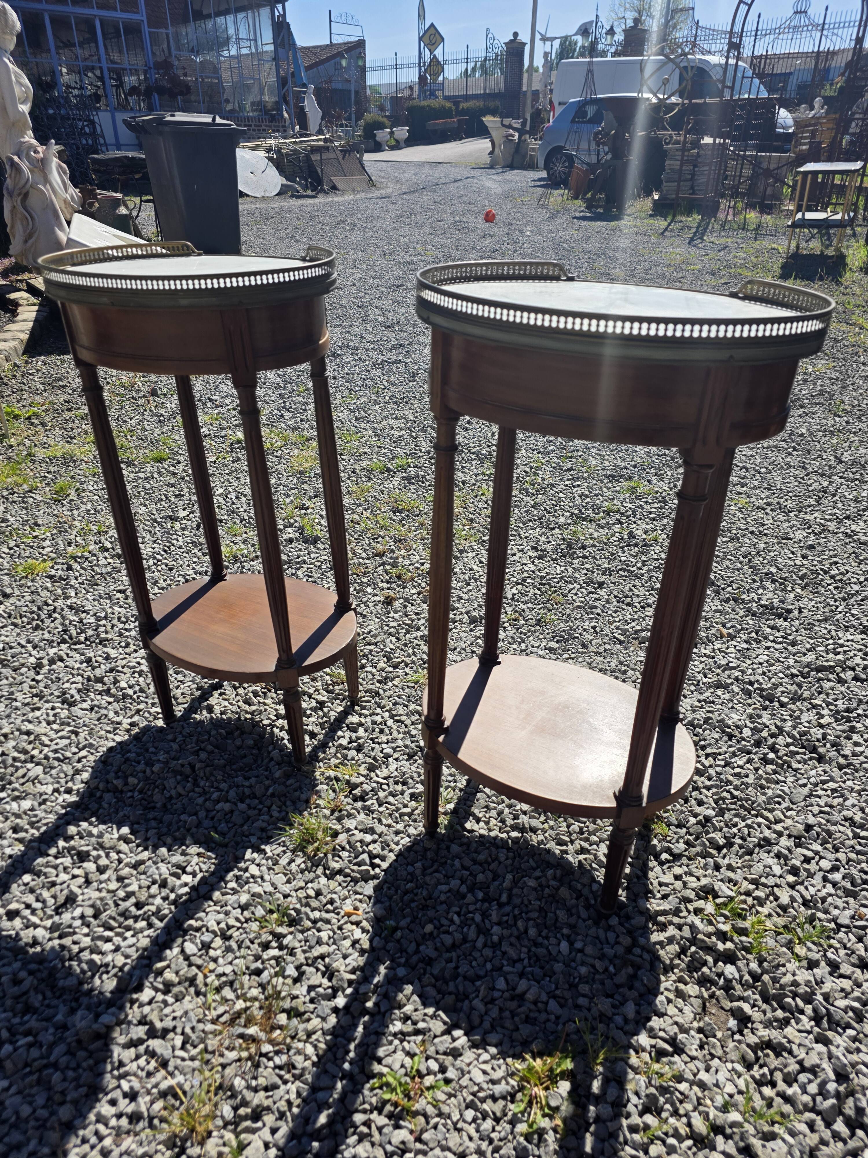 Pair of Louis XVI style bedside tables in mahogany, with marble tops.