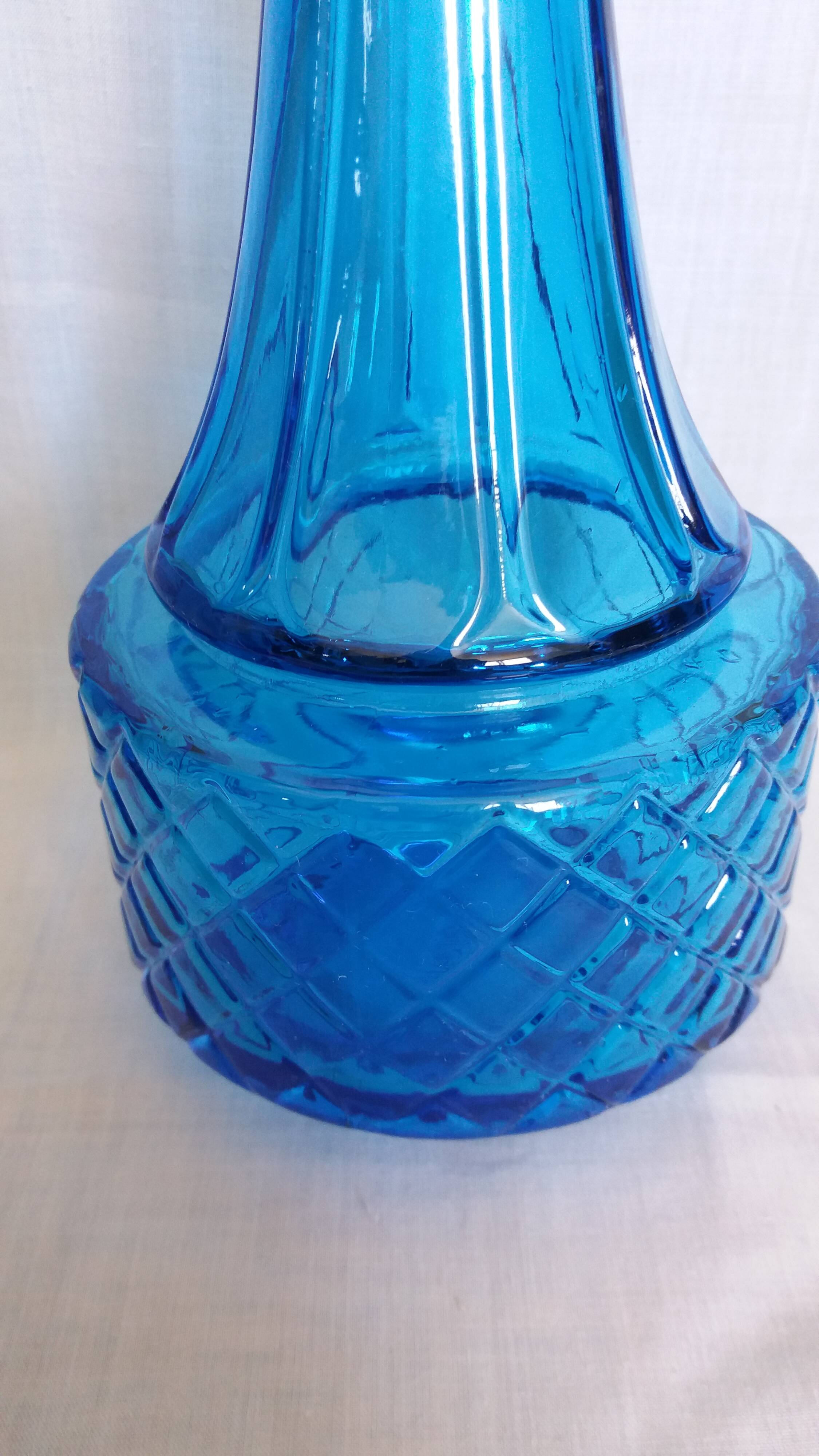 Turquoise glass carafe bottle with a stopper.