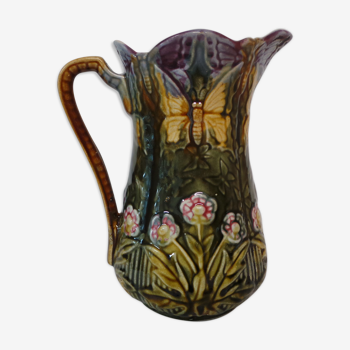 Pitcher dabbling in butterfly and flower decoration