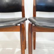 Set of four Arne Vodder chairs in hardwood and black leather.