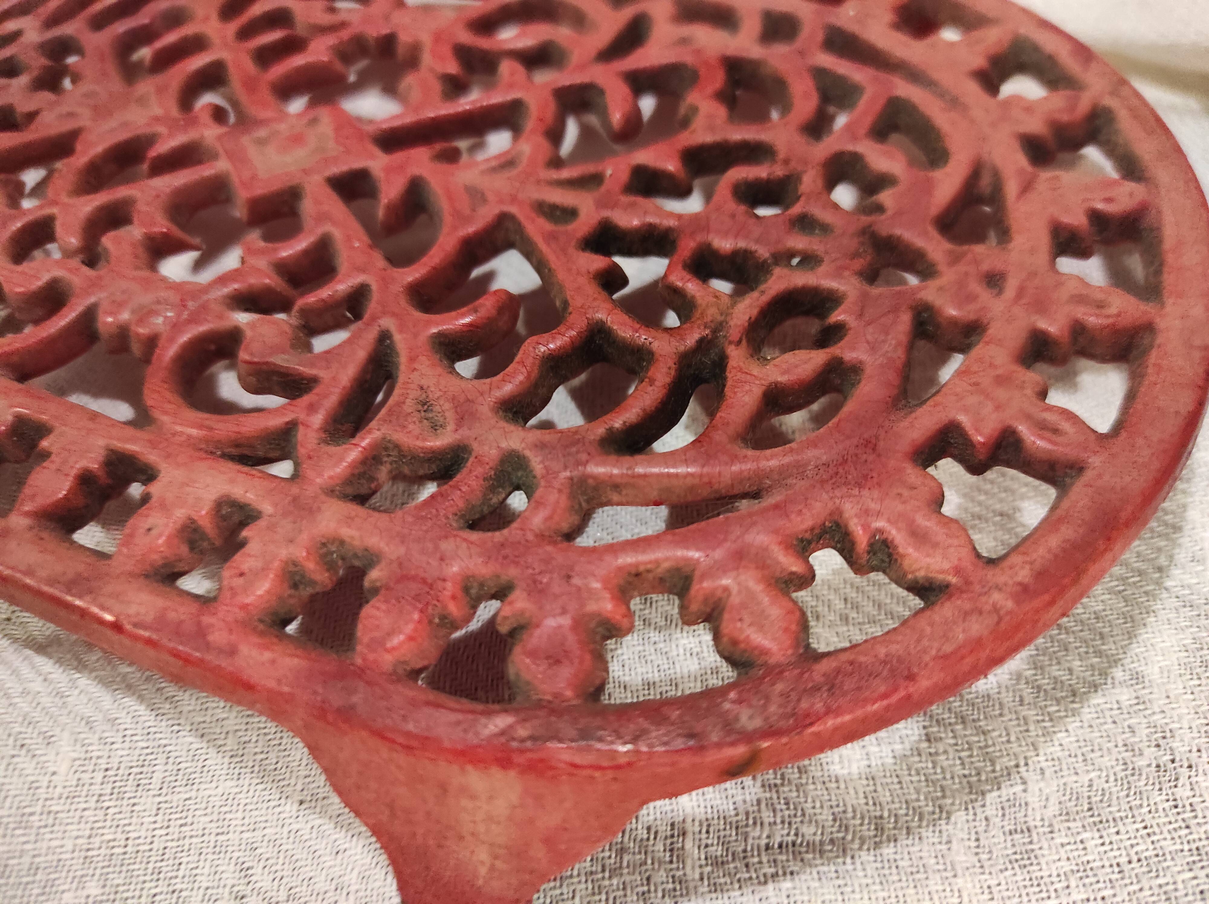 Vintage oval dark coral pink cast iron trivet