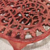 Vintage oval dark coral pink cast iron trivet