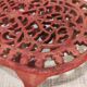 Vintage oval dark coral pink cast iron trivet
